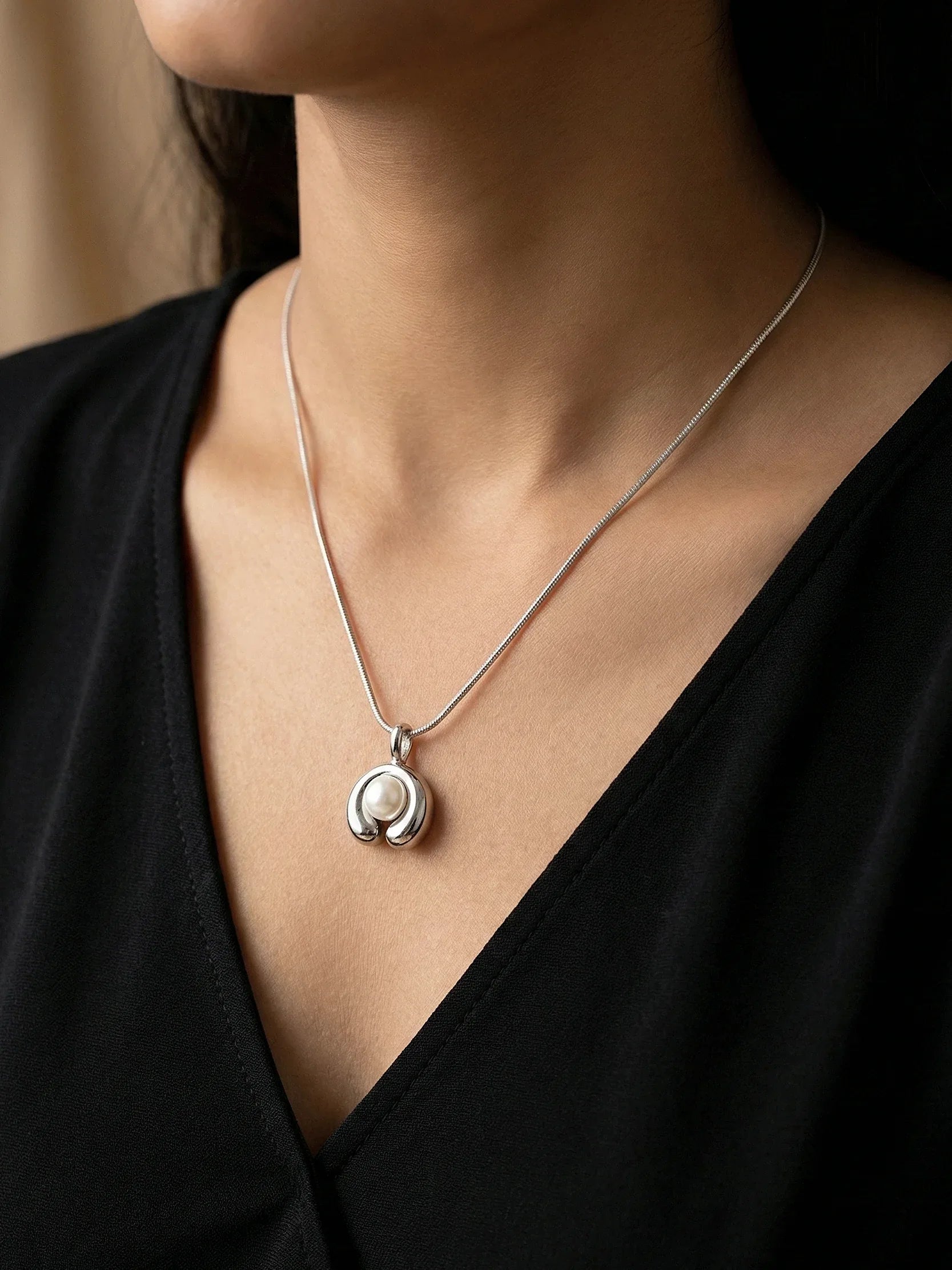 Sleek Gold Snake Chain Necklace with Round Pearl Charm - Doulaat