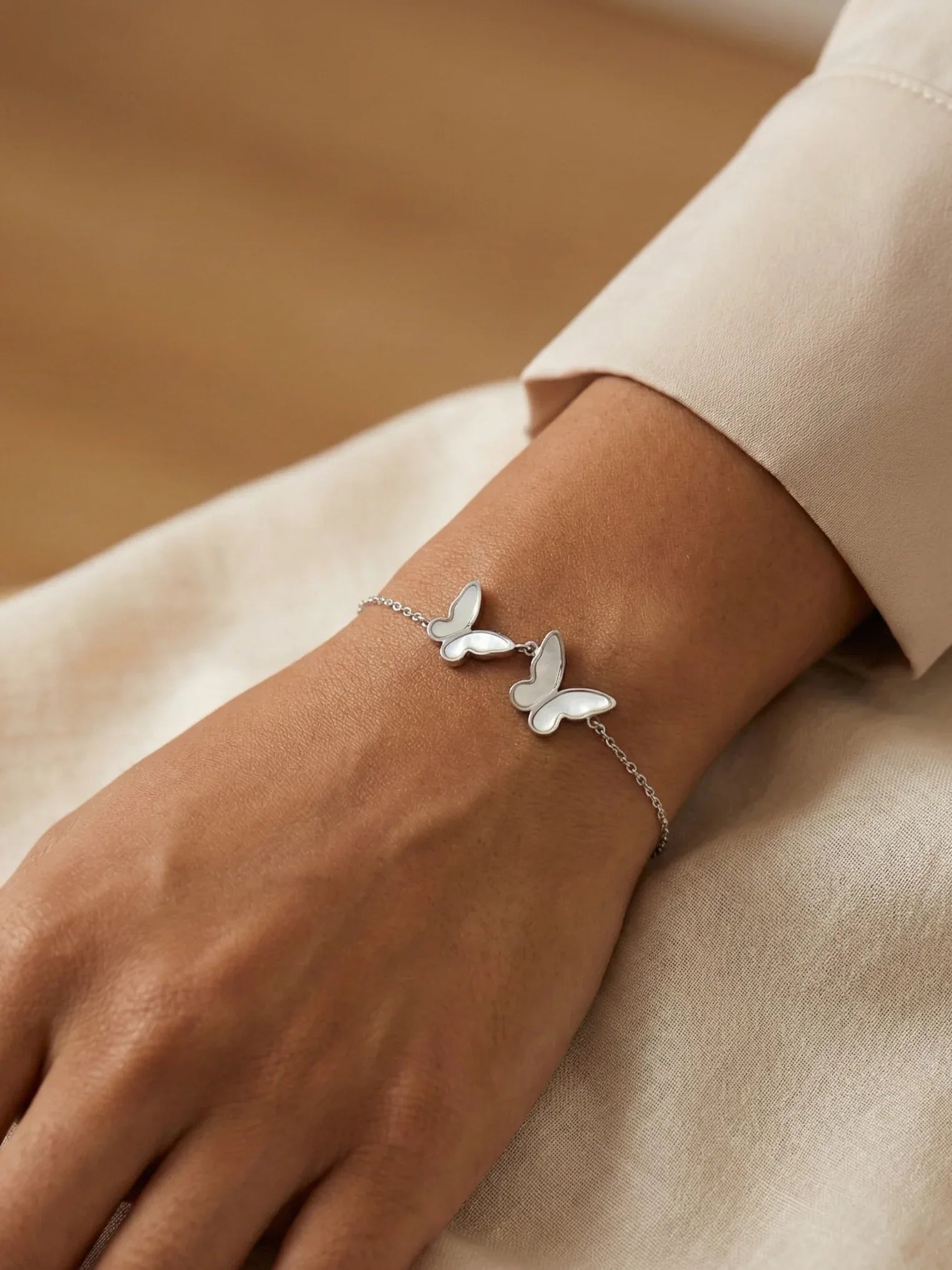 Elegant Silver Butterfly Bracelet with Soft Pearl Shine - Doulaat